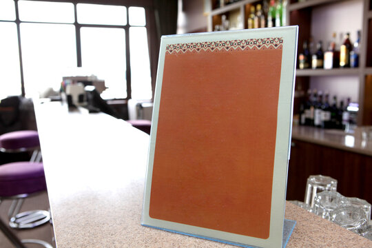 Menu table mockup with space for text. The interior of the restaurant bar in blur. Without anyone. menu concept