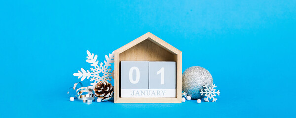 1 january. Christmas composition on colored background with a wooden calendar, with a gift box,...