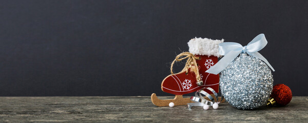 Christmas ball with skates on colored background. decoration bauble with ribbon bow with copy space