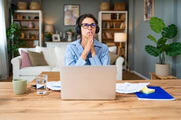 Smiling young woman working at home. Successful professional occupation female work on laptop...