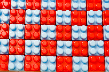 Red and blue toy blocks arranged crosswise. Educational toys for children