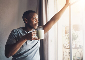 Black man, coffee and thinking by window in home for morning routine, checking weather or daydreaming. Person, smile or thoughtful with caffeine for reflection, nostalgia or happy memory to start day