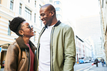 Cheerful Couple Exploring the Vibrant City Streets on a Sunlit Day