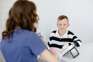 Boy testing breathing function by spirometry in doctors office. Diagnosis of respiratory function in pulmonary disease