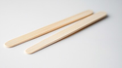 Two Simple Bamboo Wood Sticks on White Background: Natural Craft Material for Eco-Friendly Design