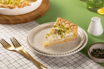 Homemade Vegetable leek Quiche Served Beautifully on a Stylish, Elegant Plate on tableware. Vegeterian dish concept