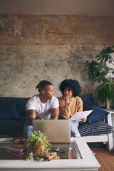 Home, budget and couple with laptop, thinking and documents for tax report on sofa. Research, man and woman on couch with financial planning paperwork, mortgage bills or online app for savings growth © R Jordaan/peopleimages.com