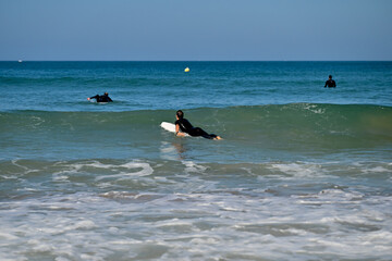 Surfing the waves, people playing in the ocean waves.