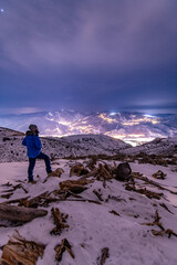 Fototapeta premium Man Standing On Winter Night Hike In the Mountains Above Avon Colorado and Beaver Creek Ski Resort 
