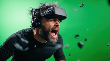 A man wearing a VR headset and headphones is immersed in a thrilling virtual reality experience, with intense emotions and debris flying around on a green backdrop.