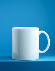 Fototapeta premium Blank white mug isolated on blue background. Mock-up.