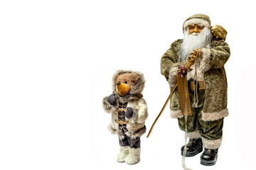 Santa Claus with a teddy bear and a bag of gifts, close-up on a white background. Christmas festival with copy space for text. Christmas and New Year holidays.