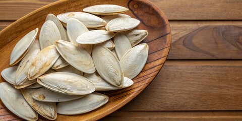 Pile of Dry Cuttlebone for Birds and Pets on Wooden Plate, Natural Animal Feed Food with Copy Space for Text or Advertising, Ideal for Bird Care, Pet Nutrition, and Wildlife Needs