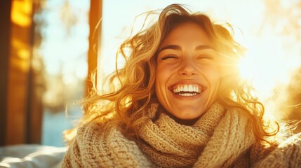 A smiling woman wrapped in a cozy knit sweater, basking in bright sunbeams. Her cheerful expression and the setting signify the warmth of winter joy.