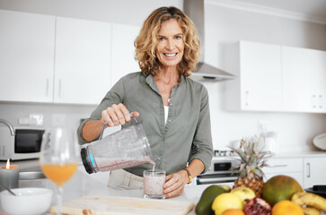 Mature woman, blender and portrait in kitchen with smoothie for nutrition, wellness and meal prep...