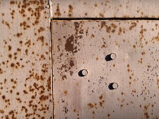 old rusty surface with peeling paint door and screws, weathered texture of rust and chipped paint...