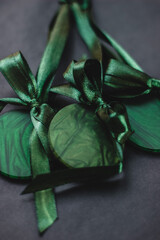 Green Christmas tree ornaments with satin bow, festive holiday decoration symbolizing seasonal joy and elegance in lush green hue