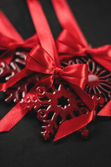 Elegant red snowflake tree ornament with satin bow, festive Christmas decoration symbolizing holiday cheer in vibrant red hue