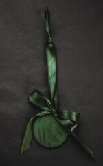 Green Christmas tree ornaments on black background, festive holiday decorations in vibrant contrast for seasonal celebrations