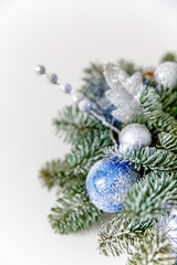Beautiful Christmas wreath decorated with pine cones, berries, and stars on a white background. Decorated christmas tree with ornaments and lights, white background for festive holiday designs.