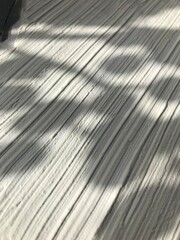 White relief texture with shadow, intricate design creating depth and dimension, abstract surface with elegant play of light and shade