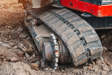 Excavator lost broken track and waiting for repair working on a construction site 