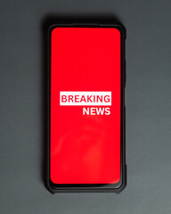 close up of breaking news text in phone on the table