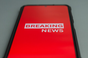 close up of breaking news text in phone on the table