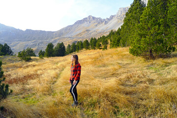 Hiking in the most beautiful places of Montenegro: a young woman enjoying autumn nature during a...
