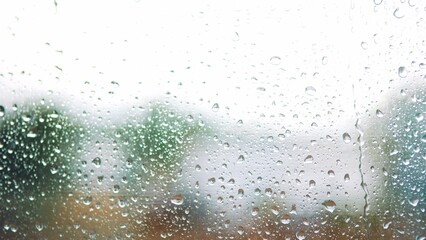 raindrop on the window in autumn a background. wet glass rain drops rainy sky blurred background close-up. rain in the window on the background of the sky blurred plan lifestyle