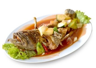 Fried grouper with sour sweet sauce. Served on white plate. Isolated from white background. Perfect for menu, catalogue, advertising or commercial use