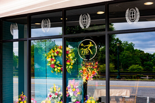 THOMASVILLE, NC, USA-8 MAY 2022: Tight view of Florist's display window, focusing on the FTD logo.