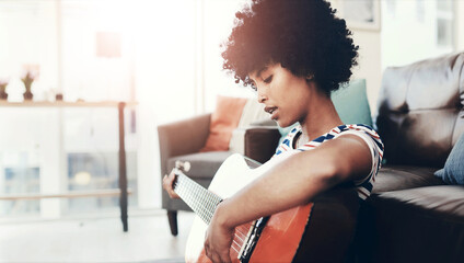 Woman, guitar and relax in home for music, learning and practice chords with talent. Girl, creative...