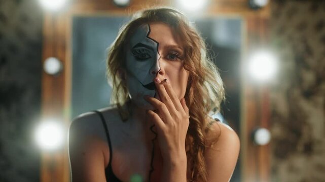 Portrait of sexual and crazy woman with makeup on half of face, look at camera. Split personality and madness, emotional burnout and psychological problems, depression and frustrated female person