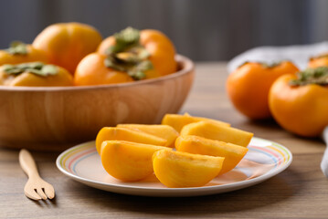 Sliced ripe persimmon ready to eating, Autumn fruit