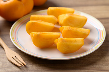 Sliced ripe persimmon ready to eating, Autumn fruit