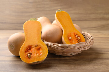 Butternut squash pumpkin in basket on wooden background