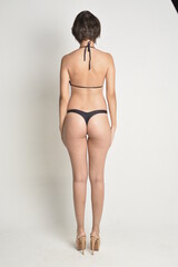 Fototapeta premium short hair, natural, no makeup, woman, white t-shirt, black pants, blue swimsuit, bikini, skates, casual, authentic, lifestyle, candid, minimal, female model, simplicity, everyday look, relaxed, comfo