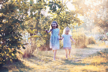 Children walk in the park in autumn. Child outdoors on a sunny summer morning in the park.