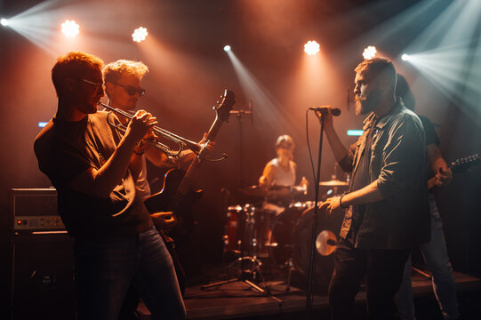 Music band playing live on stage during a concert