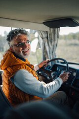 Senior bus driver smiling and driving public transportation vehicle