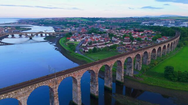 Berwick, Northumberland, UK, June 19, 2024; sunset aerial high level orbit clip of the Royal Border Bridge Viaduct, Berwick, Berwick-upon-Tweed, Northumberland, England, UK.