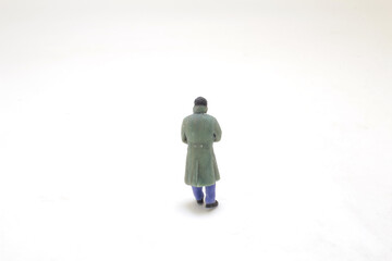 Lonely Figure In Winter Coat On Empty White Background