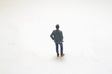 Fototapeta premium a Miniature Figurine of Casual Man on Simple