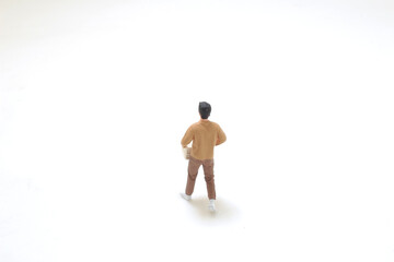 Miniature Figure Holding a Box on White Background