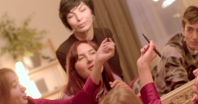 Gathering of close friends passionately enjoying creative expression and bonding moments together. Intentional Mindset Shift: Writing on the mirror reflects a desire to cultivate a positive mindset