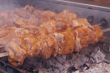 Kebabs on skewers are grilled on hot coals