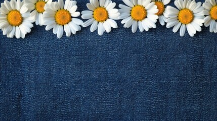 A detailed denim background with a border of daisy flowers lining the edges, their white petals and yellow centers standing out brightly against the indigo tones of the denim.
