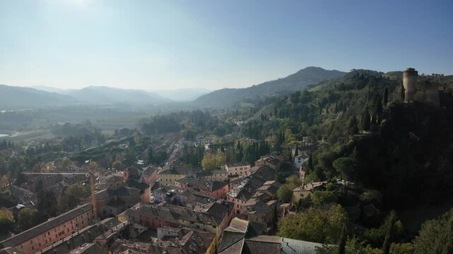 Aerial view of charming Brisighella village in Lamone valley with Monticino sanctuary in Italy and Tuscan romagnolo apennines, showcasing timeless beauty and Brisighella Castle or Rocca Manfrediana