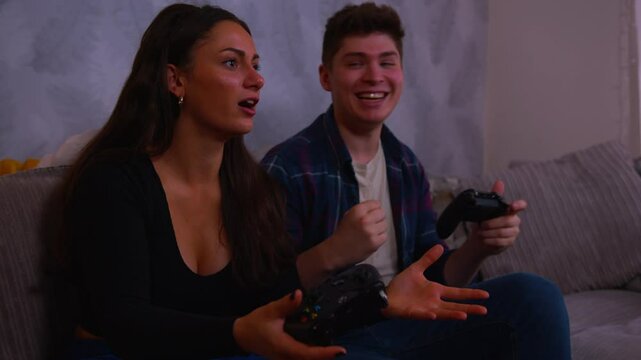 Cute couple playing video games boyfriend wins and girlfriend complains in slow motion